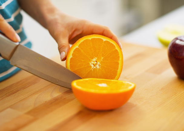 Closeup on woman cutting orange - Фото, зображення