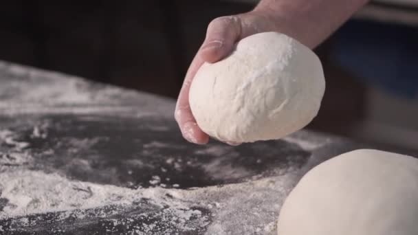 Close up view of baker hands kneading the dough on the table. Manufacturing process, making bread. Slow motion . - Footage, Video