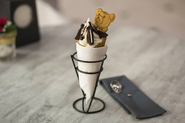 White plate with ice cream dessert in wafer cup with chocolate c - Photo, Image