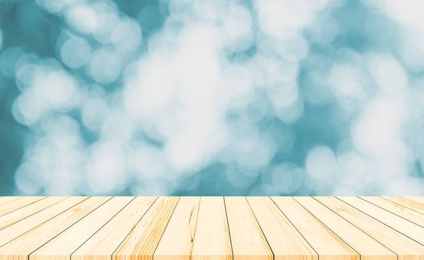 Wood table or wood floor with abstract blue bokeh background for product display - Foto, imagen