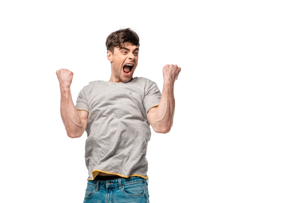 happy young man showing triumph gesture and screaming isolated on white - Photo, Image