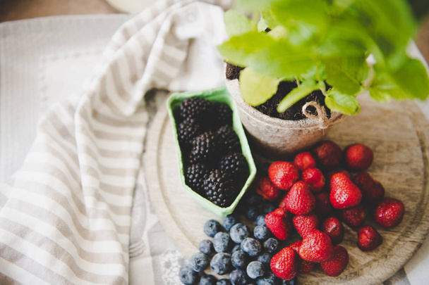 fresh strawberry blueberry and blackberry on wooden desk - Φωτογραφία, εικόνα