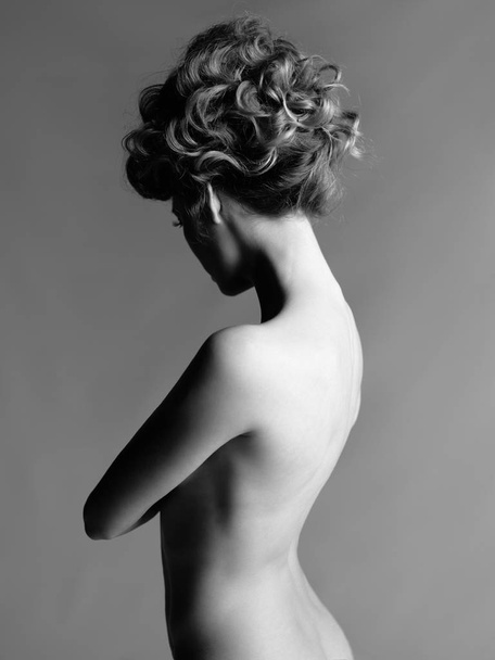 Nude woman with elegant hairstyle on gray background - Zdjęcie, obraz