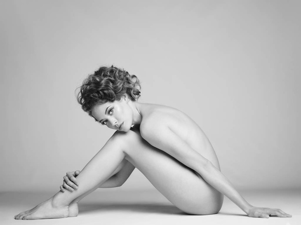 Nude woman with elegant hairstyle on gray background - Foto, afbeelding
