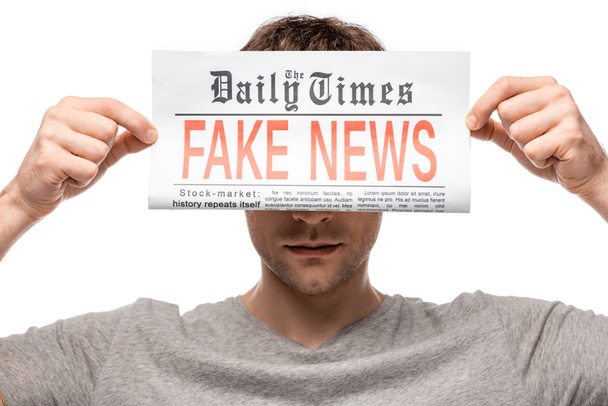 young man showing newspaper with fake news isolated on white - Foto, Imagem
