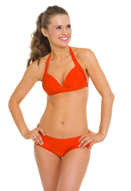 Smiling young woman in swimsuit looking on copy space - Foto, afbeelding