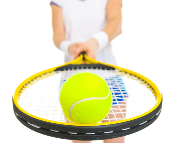 Closeup on tennis ball on racket in hand of female tennis player - Fotó, kép