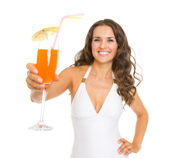 Smiling young woman in swimsuit giving cocktail - Foto, Bild