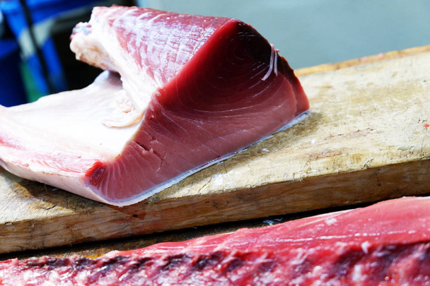 Свежий сырой кусок тунца, прямой эфир на японском утреннем рынке
 - Фото, изображение