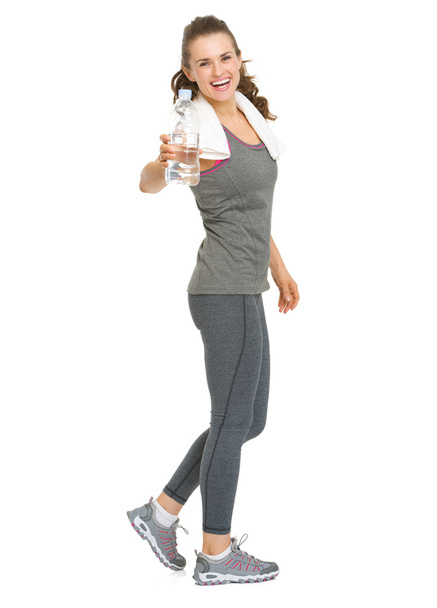 Full length portrait of happy fitness young woman giving bottle - 写真・画像