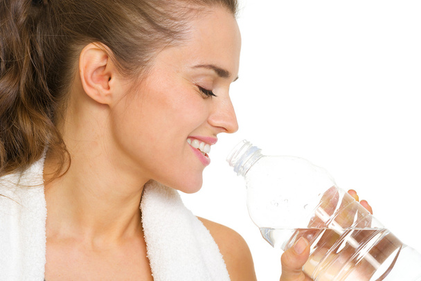 Portrait of happy young woman drinking water - Zdjęcie, obraz