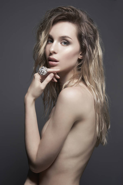 Young beautiful blonde with silver jewelry - Fotó, kép