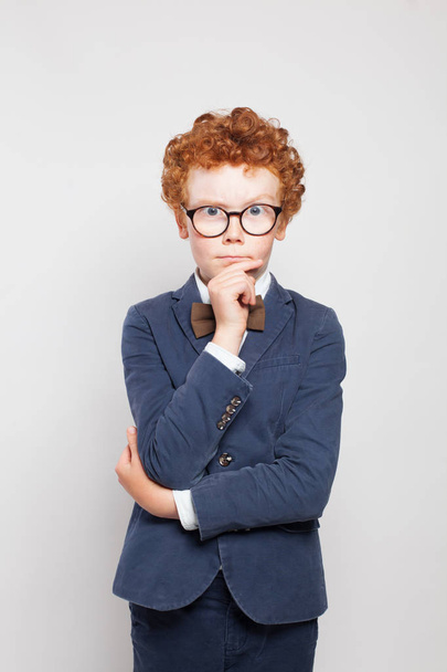 Thinking child boy with ginger hair wearing glasses and suit  - Fotoğraf, Görsel