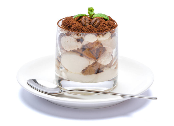 Classic tiramisu dessert in a glass on plate with spoon isolated on a white with clipping path - Foto, imagen
