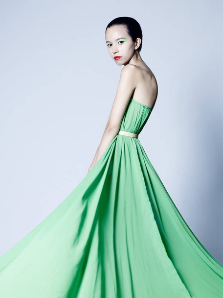 Beautiful asian woman in green dress - Фото, зображення