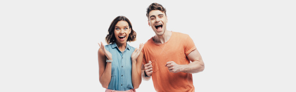 excited man and woman looking at camera and showing yes gestures isolated on grey - Photo, Image