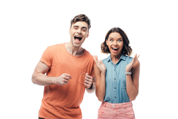 excited man and woman smiling at camera and showing yes gestures isolated on white - Foto, Bild