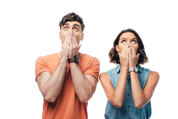 shocked man and woman looking up and covering faces with hands isolated on white - Fotoğraf, Görsel