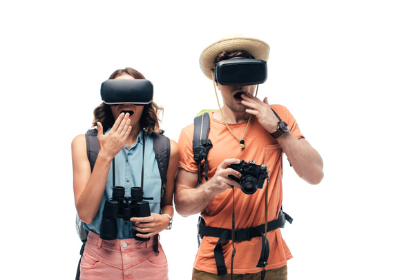 two young shocked tourists using virtual reality headsets isolated on white - Photo, Image