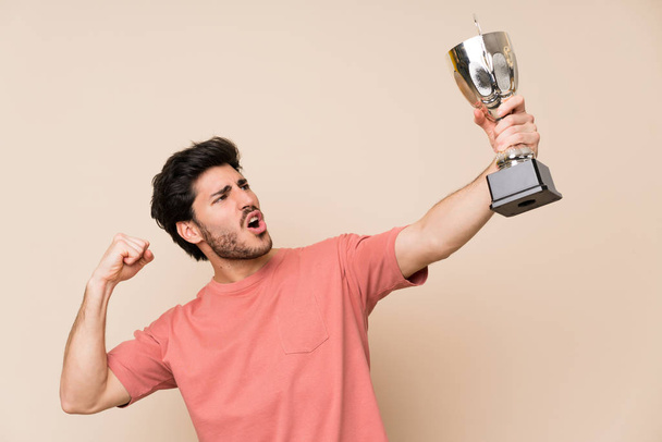 Przystojny mężczyzna trzyma trofeum - Zdjęcie, obraz
