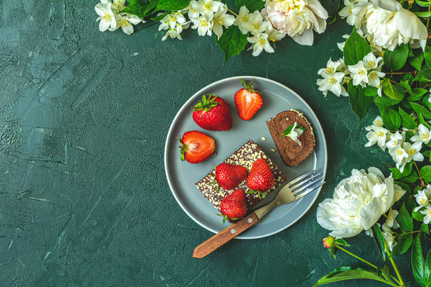 Chocolate rollcake with fresh strawberries in ceramic plate - Foto, imagen