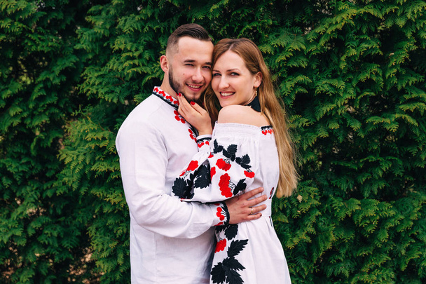 newlyweds hug and look at the camera. embroidered clothes. close - Photo, Image