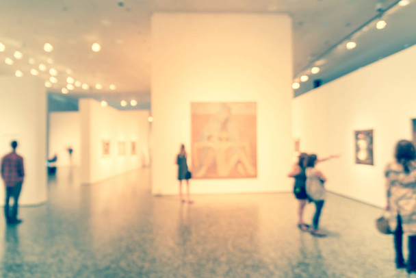 Blurry background people looking at fine art display at museum in America - Photo, Image