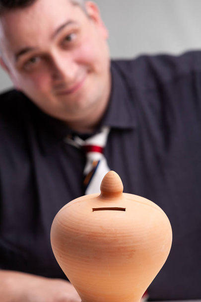 Smiling successful businessman with a money box - Photo, Image