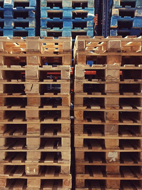 Many pallets stacked in stock, warehouse pallets, blue wooden pallets - Photo, Image