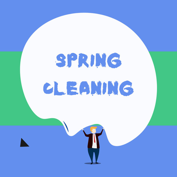 Text sign showing Spring Cleaning. Conceptual photo practice of thoroughly cleaning house in the springtime Front view standing man dressed suit tie two hands up big deflated balloon. - Photo, Image