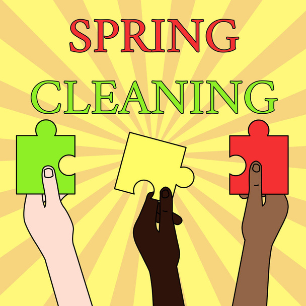 Writing note showing Spring Cleaning. Business photo showcasing practice of thoroughly cleaning house in the springtime Three Colored Empty Jigsaw Puzzle Pieces Held in Different People Hands. - Photo, Image
