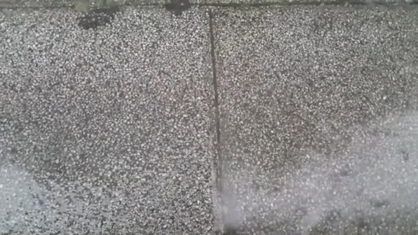 Крупним планом вид крапель дощової води робить брижі на сірих цеглинах
 - Кадри, відео