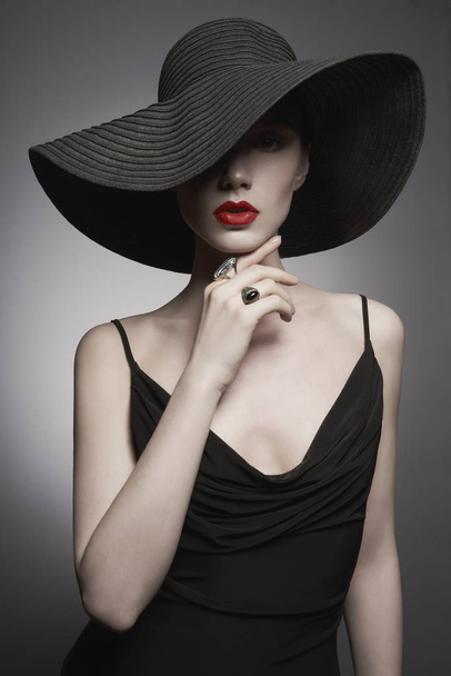 portrait of young lady with black hat and evening dress - Фото, изображение