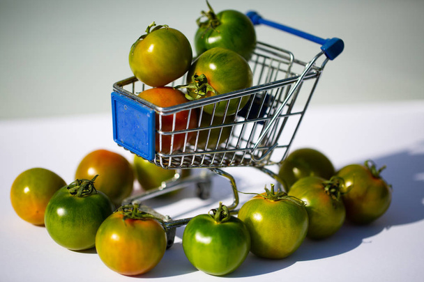 groene camone tomaten in winkelmandje - Foto, afbeelding