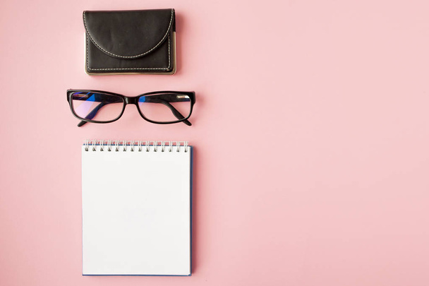 Stationery, white smartphone, glasses, pen, wallet, watch, calendar, notebook. Pink background. - Foto, immagini