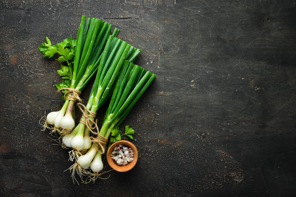 Slice green onions on a Wooden Table. Fresh vegetables. Top view. Free space for text. - Valokuva, kuva