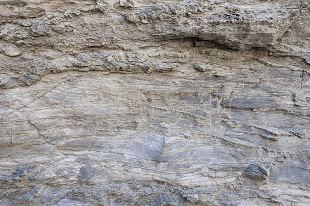 岩盤表面の自然な質感で、時間の長い岩に描かれた線を見ることができます。背景として使用できます. - 写真・画像