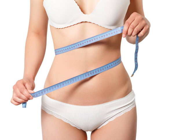Woman measuring her slim body isolated on white background - Valokuva, kuva