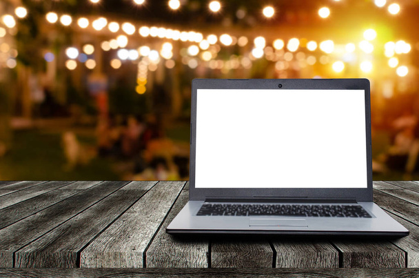 laptop notebook computer with white blank screen on desk with night light bokeh of night festival in garden, advertisement, workspace, internet technology, online social media, searching data concept - Foto, Imagem