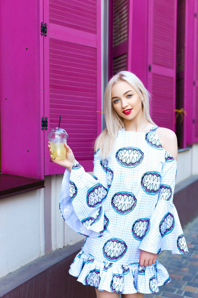 girl blonde walks down the street with lemonade - Foto, Imagen