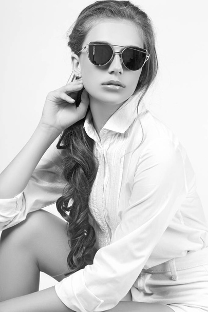 Teen girl posing in studio on white background. Black and white  - Fotó, kép