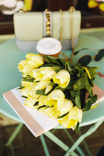 bouquet of yellow tulips on the table - 写真・画像
