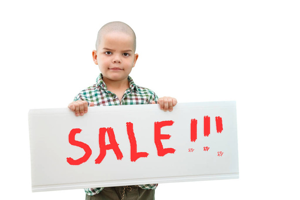 boy holding a sign "SALE" in the hands. In light background. - Фото, изображение