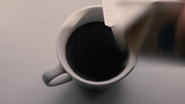 add milk to coffee - Materiał filmowy, wideo