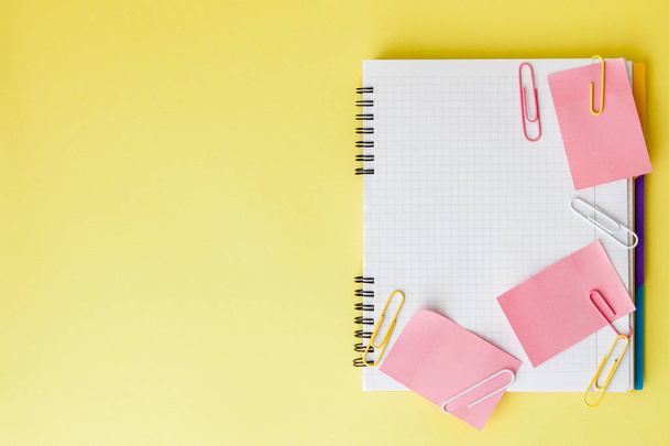Back to school concept with space for text. Top view. Copy space. School office supplies.Creative desk with colourful stationery. Colored paper clip.School supplies on yellow background.Office desk - Foto, Imagen