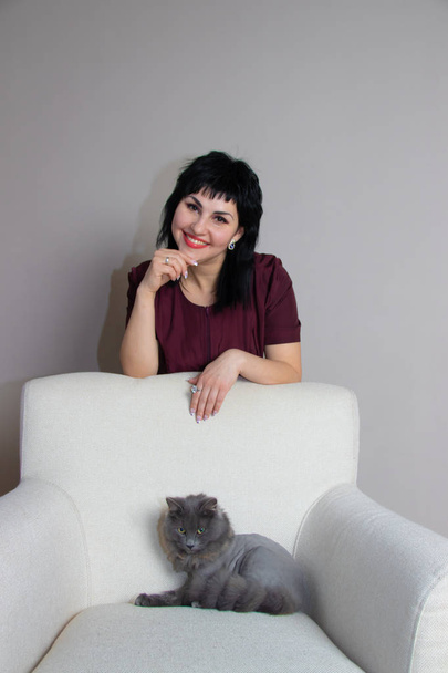 hermosa mujer en traje médico con gato gris
 - Foto, Imagen