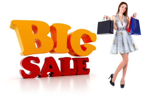 Young woman with shopping bags and a big 3d SALE text - Фото, изображение