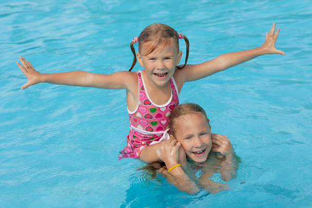 two little girls playing in the pool - Photo, Image