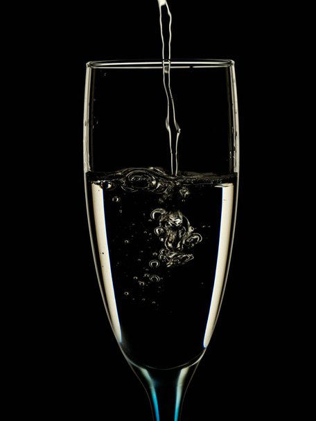 Elegant picture in glasses is poured with clean water on a black background - Fotoğraf, Görsel