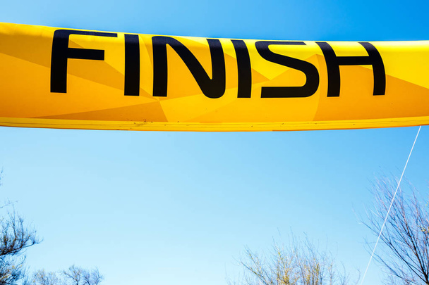 Word Finish on a yellow banner against a blue sky. - Photo, Image